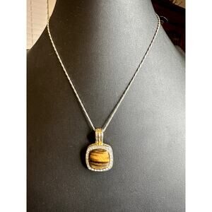 Two tone silver and gold tone Cat eye surrounded by rhinestones magnetic pendant